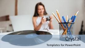  Presentation with vinyl record - Presentation design consisting of photo of casual woman working on a laptop sitting on the chair in the house while holding camera focus on table with vinyl record and pencils background and a light blue colored foreground