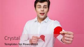  Presentation with give - Colorful theme enhanced with photo of young man standing isolated over pink background give you a two halves of heart looking camera focus on heart backdrop and a coral colored foreground