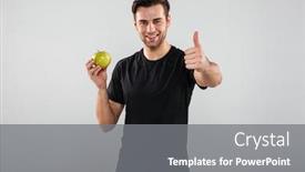  Presentation with sports - Cool new PPT theme with picture of happy young sports man posing isolated over grey wall background looking camera holding apple showing thumbs up backdrop and a gray colored foreground