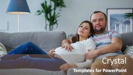  Presentation with pregnant woman - Amazing PPT layouts having picture of pregnant woman and man on gray sofa backdrop and a violet colored foreground
