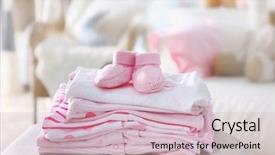  Presentation with baby clothes - PPT theme consisting of pile of baby clothes close up background and a soft green colored foreground