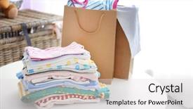  Presentation with baby clothes - Theme with pile of baby clothes close background and a light gray colored foreground