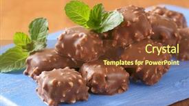  Presentation with chocolate nuts - Theme consisting of pile of chocolate truffles with chopped nuts on blue cutting board - close up background and a tawny brown colored foreground