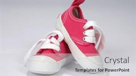  Presentation with baby shoes - Amazing theme having pink baby shoes over gray background backdrop and a light gray colored foreground