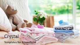 Presentation with new baby - Audience pleasing slides consisting of pink blue - new baby clothes on bed backdrop and a soft green colored foreground