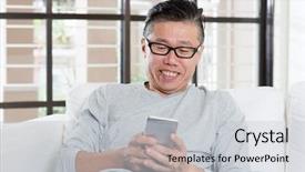  Presentation with smart home - Presentation theme enhanced with portrait of 50s mature asian man texting using smart phone sitting on sofa at home background and a light gray colored foreground