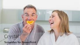  Presentation with orange slice - PPT theme featuring portrait of a cheerful couple with orange slice in the kitchen at home background and a light gray colored foreground