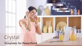  Presentation with computer music - Slide deck having portrait of a cheerful young woman listening to music with headphones and using laptop computer while standing at the kitchen background and a lemonade colored foreground