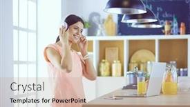  Presentation with computer music - Presentation having portrait of a cheerful young woman listening to music with headphones and using laptop computer while standing at the kitchen background and a coral colored foreground