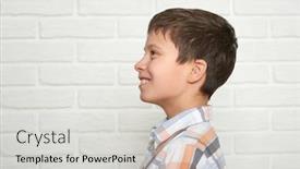  Presentation with white brick - PPT theme having portrait of a emotional boy standing near white brick wall dressed in a plaid shirt background and a light gray colored foreground