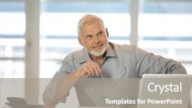  Presentation with front desk - PPT layouts consisting of portrait of a senior man sitting at a desk in front of a laptop computer background and a gray colored foreground