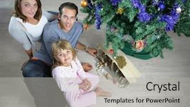  Presentation with family tree - Presentation theme with portrait of a smiling family sitting on the floor next to christmas tree background and a light gray colored foreground