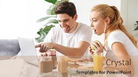  Presentation with computer love - Colorful theme enhanced with portrait of an excited young couple in love using laptop computer while having tasty breakfast at the table in a kitchen backdrop and a coral colored foreground