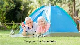  Presentation with tent - PPT theme with portrait of smiling senior couple with torch and map in tent at park background and a mint green colored foreground