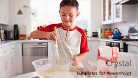  Presentation with teen - Slides with pre-teen boy making a cake in the kitchen mixing cake mix smiling close up background and a soft green colored foreground
