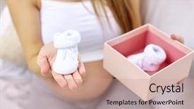  Presentation with motherhood - Slide deck with pregnancy motherhood people and expectation concept - close up of happy pregnant woman holding box with babys bootees at home background and a coral colored foreground
