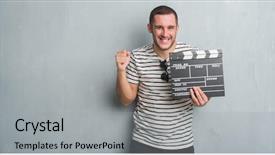  Presentation with clapboard - Cool new slides with production achievement - young caucasian man over grey backdrop and a light gray colored foreground