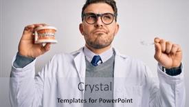  Presentation with orthodontics - Amazing PPT theme having professional-dentist-doctor-holding-denture backdrop and a lemonade colored foreground