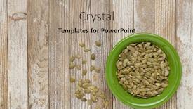  Presentation with pumpkin seeds - Slides enhanced with pumpkin seeds in a green ceramic bowl on grunge white painted wood table background and a coral colored foreground