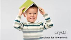  Presentation with childhood - Colorful presentation enhanced with reading education and childhood concept - portrait of smiling little boy with book on head as house roof top over grey background backdrop and a light gray colored foreground