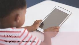 Presentation with school desk - Colorful slide deck enhanced with rear view of an african schoolboy using digital tablet at desk in classroom at school backdrop and a soft green colored foreground