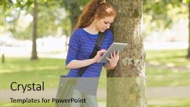  Presentation with college campus - Cool new slides with redhead student leaning against a tree using her tablet pc on college campus backdrop and a yellow colored foreground