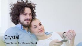 Presentation with television watching - Amazing PPT theme having remote control - young couple on the sofa backdrop and a  colored foreground