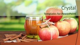 Presentation with cinnamon - Presentation theme featuring ripe apples with with cinnamon sticks and glass of apple drink on wooden table on bright background background and a soft green colored foreground