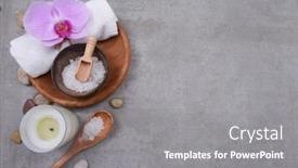 Presentation with spa concept stone - Colorful presentation theme enhanced with rolled towels and herbal ball salt spoon in wooden bowl stone and orchid flowers oil in bowl on grey background spa concept place for text backdrop and a gray colored foreground
