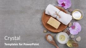  Presentation with pink flowers - Audience pleasing presentation design consisting of rolled towels and soap in wooden bowl candles stone and pink orchid flowers oil in bowl salt inspoon on grey background place for text backdrop and a gray colored foreground