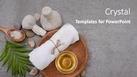  Presentation with spa concept stone - Presentation design featuring rolled towels and spa oil in wooden bowl sea salt in spoon candles stone and green palm and herbal ball on grey background spa concept place for text background and a gray colored foreground