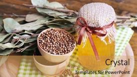  Presentation with green glass - Beautiful presentation theme featuring round wooden bowls of seasoning bay leaves and a glass bottle of honey on a green napkin on a tray on wooden background backdrop and a yellow colored foreground