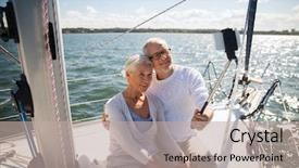  Presentation with yacht - Cool new theme with sailing age travel technology and people concept - happy senior couple with smartphone selfie stick taking picture on sail boat or yacht deck floating in sea backdrop and a mint green colored foreground
