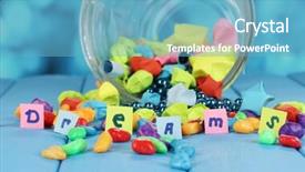  Presentation with dreams - Slides enhanced with scattered pieces of paper and colored stones with dreams in glass vase on blue wooden table on blue background background and a teal colored foreground