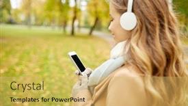  Presentation with music headphones - Presentation having season technology and people concept - close up of beautiful happy young woman with headphones listening to music on smartphone walking in autumn park background and a yellow colored foreground