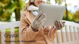  Presentation with computer music - Cool new presentation theme with season technology and people concept - close up of beautiful happy young woman with tablet pc computer and headphones listening to music and sitting on bench in autumn park backdrop and a coral colored foreground