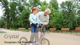  Presentation with teaching - Audience pleasing theme consisting of senior man teaching his granddaughter how to ride kick scooter in park backdrop and a soft green colored foreground