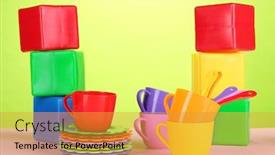  Presentation with light green - Cool new slides with set of children's dishes and cubes on table on light green background backdrop and a gold colored foreground