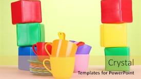  Presentation with light green - Presentation design featuring set of children's dishes and cubes on table on light green background background and a yellow colored foreground