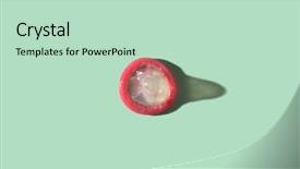  Presentation with condom - Cool new theme with sexually transmitted disease - rolled-up condom on a green backdrop and a soft green colored foreground