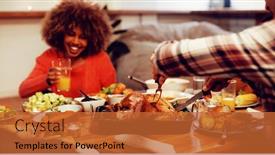  Presentation with thanksgiving dinner - Presentation theme consisting of side view of a young mixed race man sitting at a table for thanksgiving dinner at home with friends carving the turkey a smiling young mixed race woman holding a glass of orange juice in background and a red colored foreground