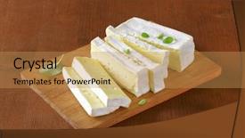  Presentation with cow milk - Amazing theme having sliced block of surface ripened cow's milk cheese served on the wooden cutting board backdrop and a yellow colored foreground