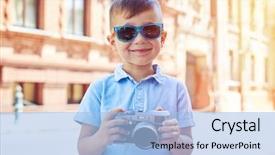  Presentation with old buildings - Cool new slides with small boy in sunglasses is posing with a photo camera in his hands on the background of old buildings during walk on a summer sunny day backdrop and a light blue colored foreground