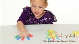  Presentation with play therapy - Audience pleasing PPT theme consisting of small child with finger paints backdrop and a soft green colored foreground