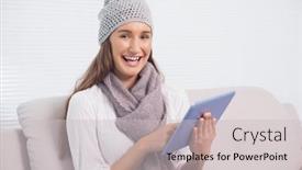  Presentation with scrolling - Amazing PPT theme having smiling cute brunette with winter hat on scrolling on her tablet sitting on cosy sofa backdrop and a light gray colored foreground