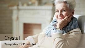  Presentation with elderly - Audience pleasing presentation design consisting of smiling elderly woman with natural make-up looking away while sitting on cozy armchair by fireplace backdrop and a coral colored foreground