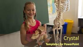  Presentation with elementary - PPT theme having smiling-schoolgirl-holding-anatomical-model background and a tawny brown colored foreground