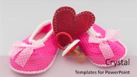  Presentation with baby shoes - PPT theme having space knitted baby booties crochet background and a coral colored foreground