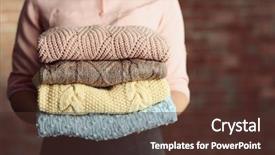  Presentation with knitted clothes - PPT theme consisting of stack of knitted clothes in female hands on blurred wall background background and a tawny brown colored foreground