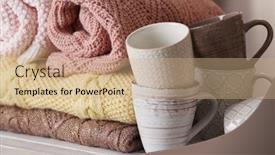  Presentation with knitted clothes - PPT theme consisting of stack of knitted clothes and cups on wooden table indoors background and a coral colored foreground
